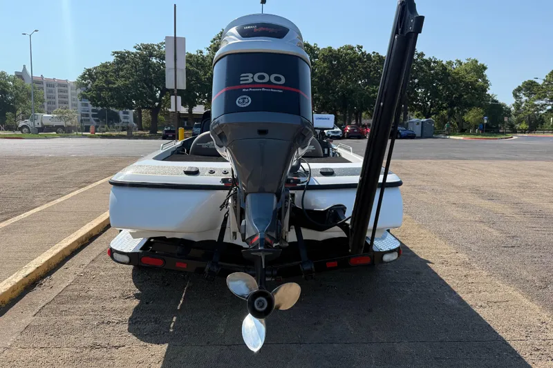Slide: The Image of 2004 Skeeter ZX250 boat with Yamaha 300 engine, parked on a trailer. - 10