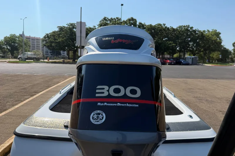 Slide: The Image of 2004 Skeeter ZX250 with Yamaha VMAX 300 engine in a parking lot. - 12