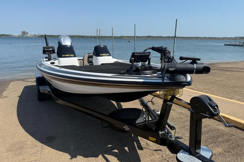 Slide: The Image of 2004 Skeeter ZX250 boat on trailer by a lake, ready for launch. - 21