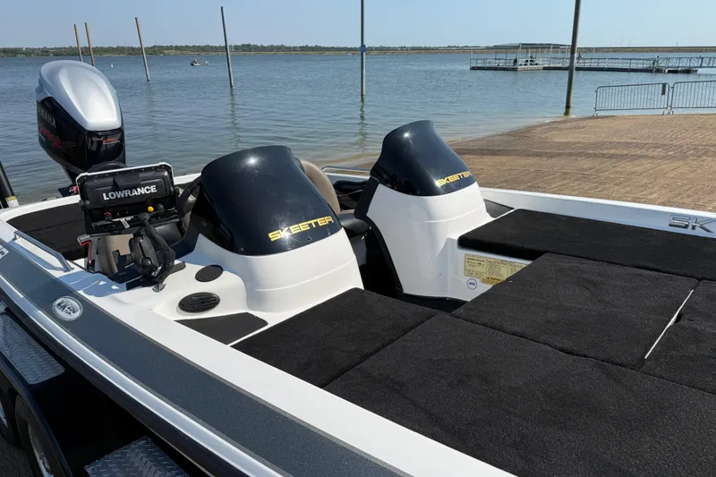 Slide: The Image of 2004 Skeeter ZX250 boat with Yamaha motor and Lowrance equipment by a lakeside dock. - 28