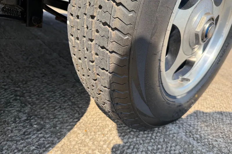 Slide: The Image of Close-up of a 2004 Skeeter ZX250 tire on a textured surface. - 39