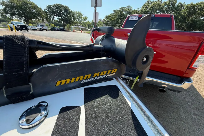 Slide: The Image of Minn Kota Maxxum Pro motor on 2004 Skeeter ZX250, parked near red truck. - 43