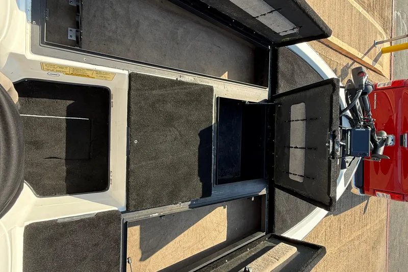 Slide: The Image of 2004 Skeeter ZX250 boat interior with open storage compartments and visible equipment. - 47