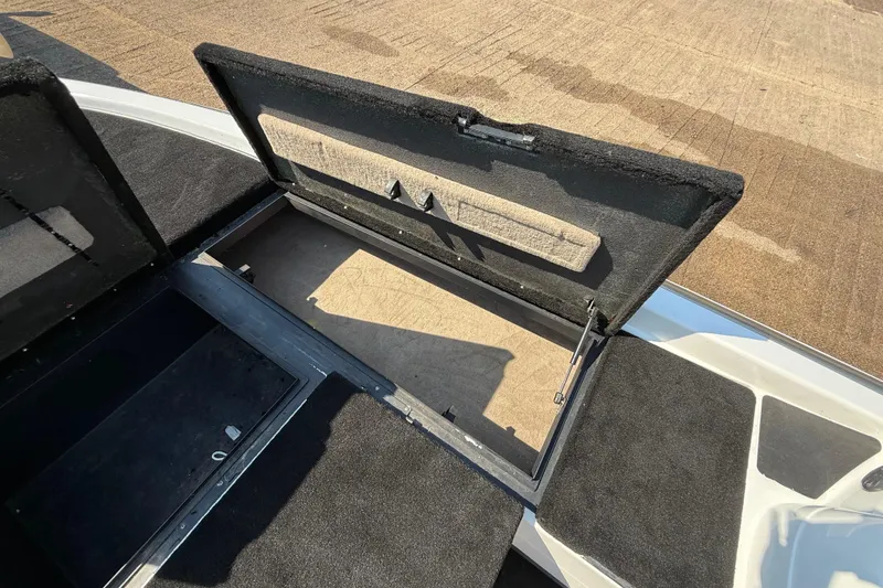 Slide: The Image of Open storage compartment on a 2004 Skeeter ZX250 boat, showcasing interior space. - 50
