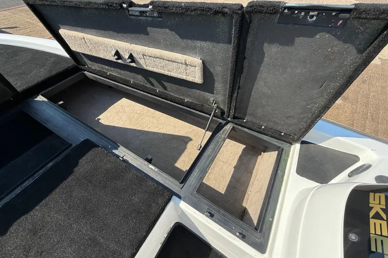 Slide: The Image of Open storage compartment on a 2004 Skeeter ZX250 boat, showcasing interior space. - 52