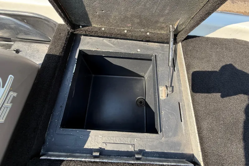 Slide: The Image of Open storage compartment on a 2004 Skeeter ZX250 boat, showing interior details. - 60