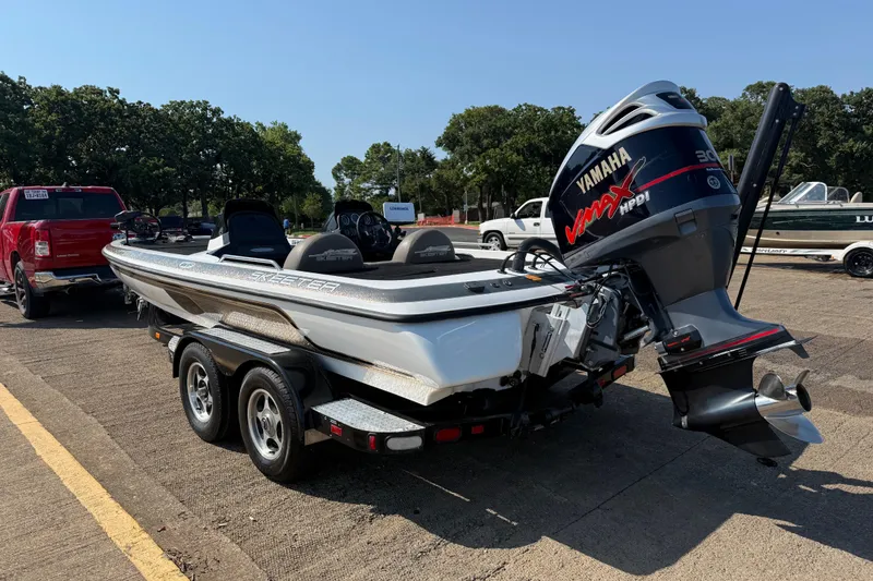 Slide: The Image of 2004 Skeeter ZX250 boat with Yamaha VMAX engine on trailer in parking lot. - 8