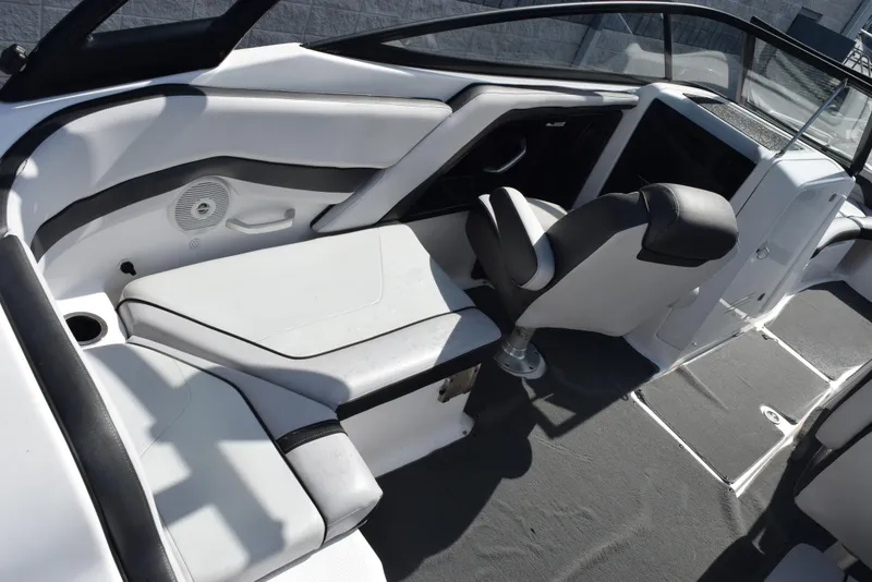 Slide: The Image of 2017 Yamaha AR240 boat interior with seating and steering area. - 10