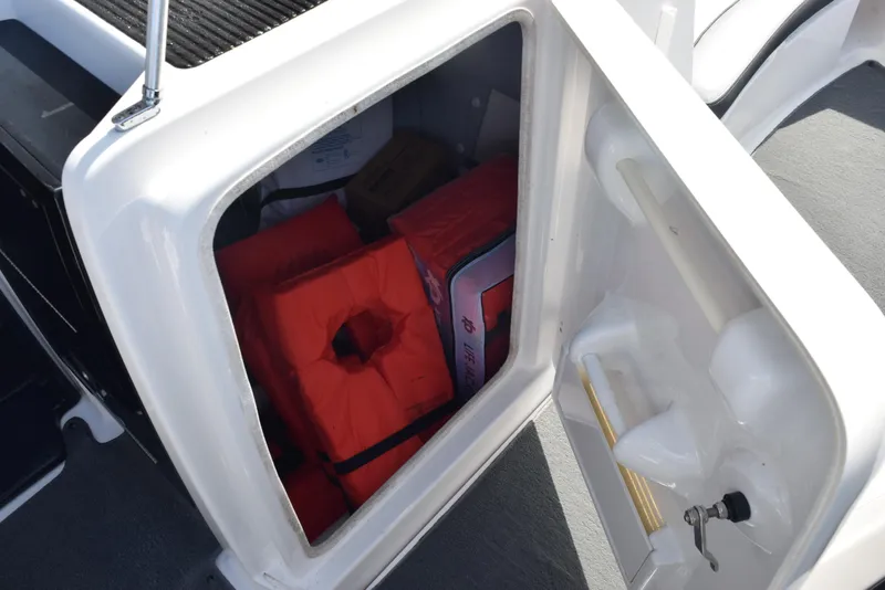 Slide: The Image of Storage compartment of 2017 Yamaha AR240 boat with life jackets and safety equipment. - 16