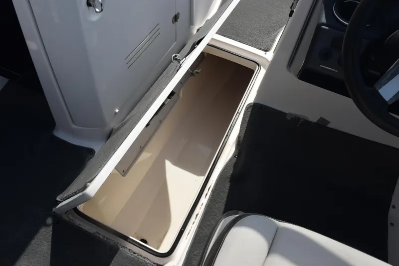 Slide: The Image of Open storage compartment on 2017 Yamaha AR240 boat interior. - 17
