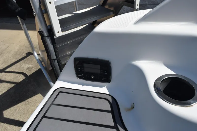 Slide: The Image of 2017 Yamaha AR240 boat interior with control panel and cup holder. - 24