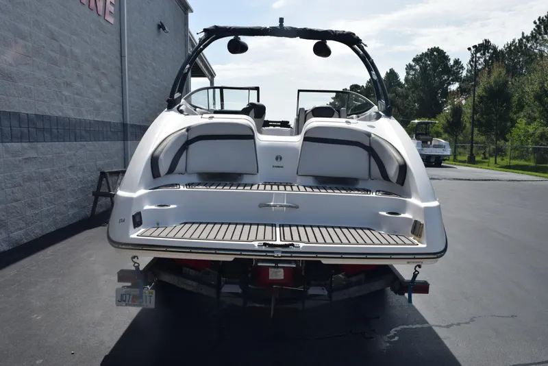 Slide: The Image of 2017 Yamaha Boats AR240 on trailer, rear view, parked outdoors. - 5