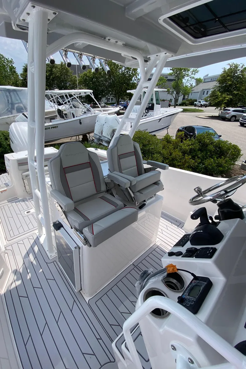 Slide: The Image of 2025 Solara S-250 CW boat interior with dual captain's chairs and modern control panel. - 13