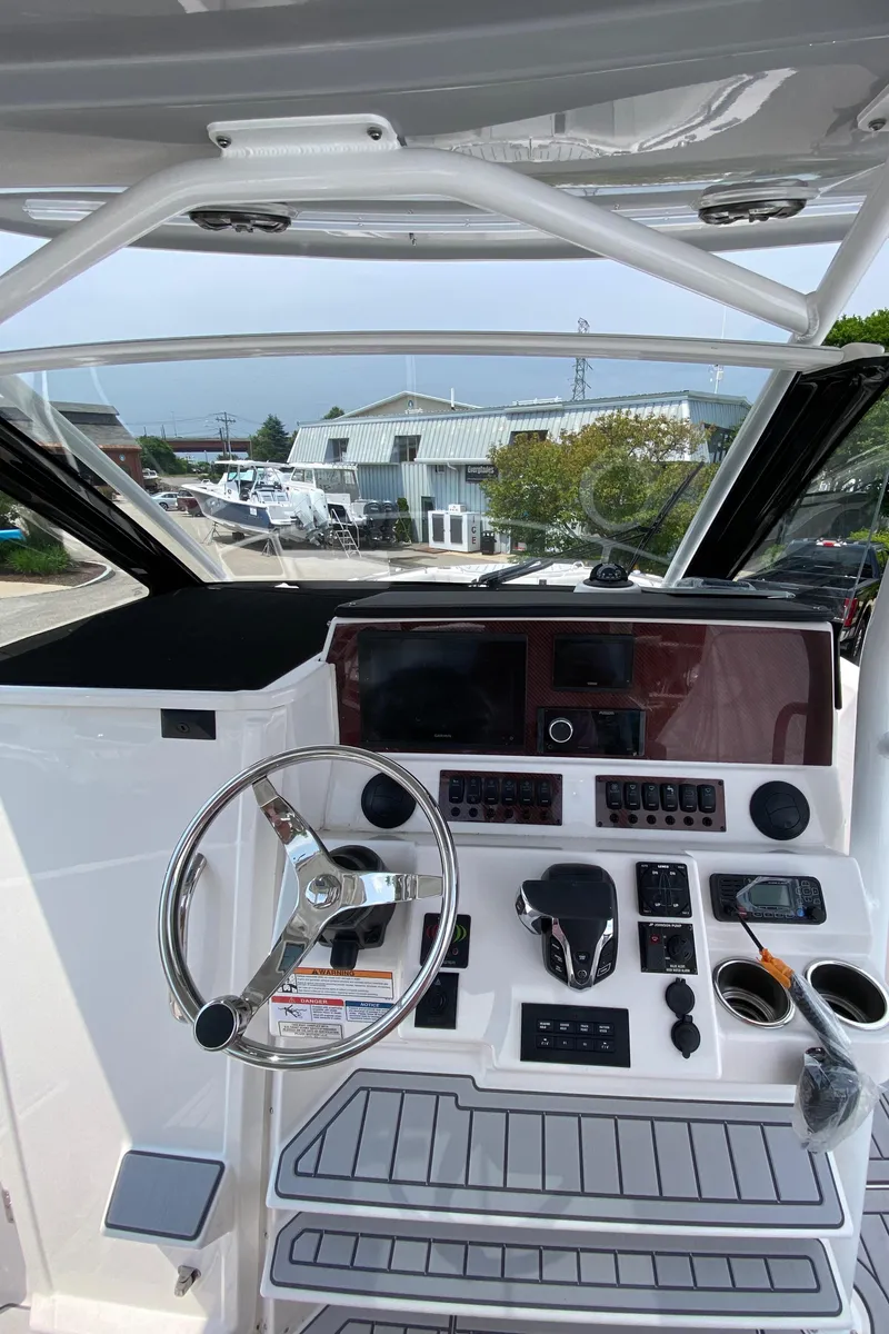 Slide: The Image of 2025 Solara S-250 CW boat dashboard with steering wheel and control panel. - 14