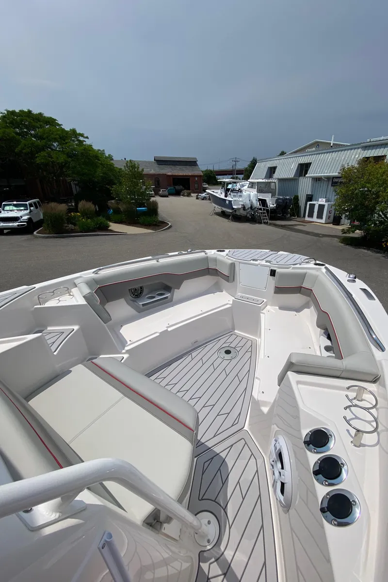 Slide: The Image of 2025 Solara S-250 CW boat with spacious seating and modern design in a marina setting. - 16
