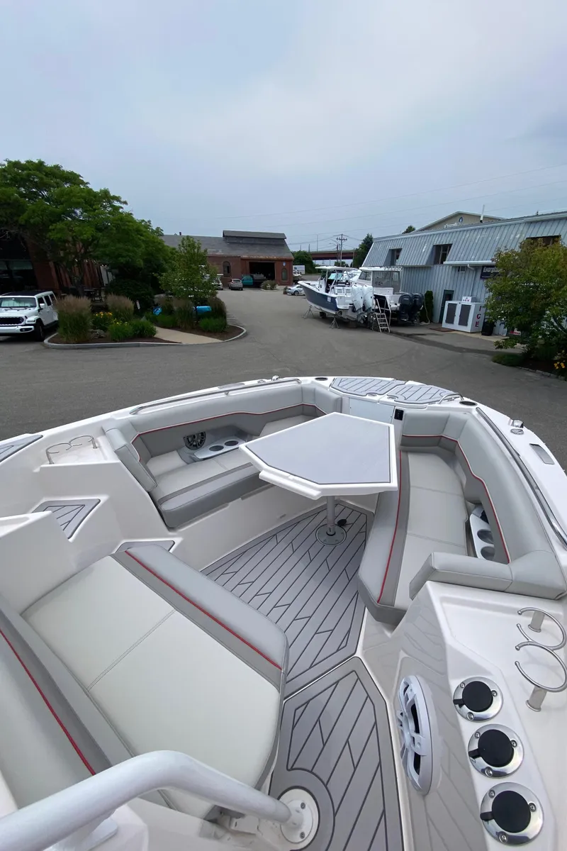 Slide: The Image of 2025 Solara S-250 CW boat with spacious seating and table, docked in a marina. - 18