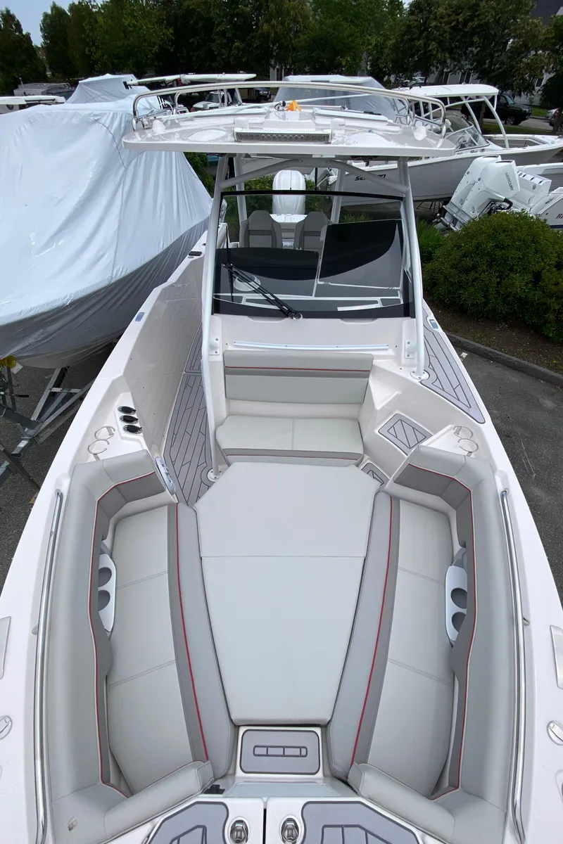 Slide: The Image of 2025 Solara S-250 CW boat with spacious seating and modern design in a marina setting. - 20