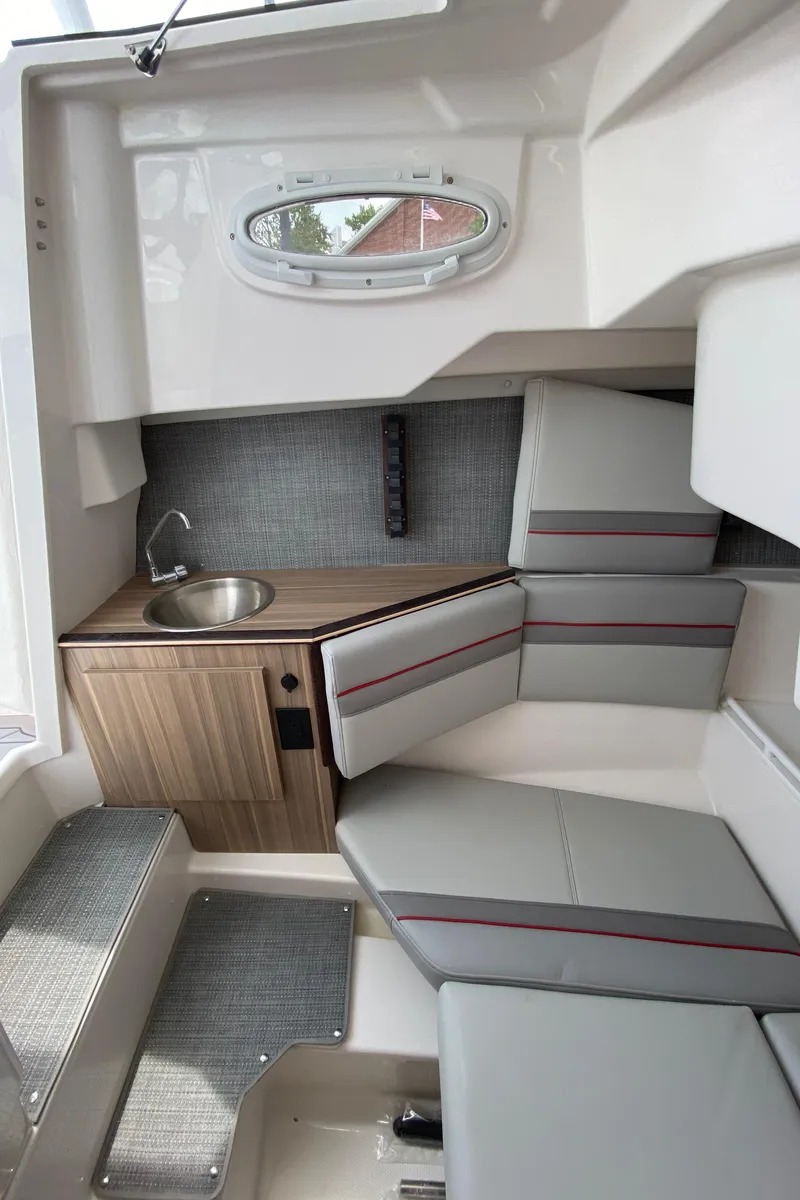 Slide: The Image of Interior of 2025 Solara S-250 CW boat with seating, sink, and modern design. - 22