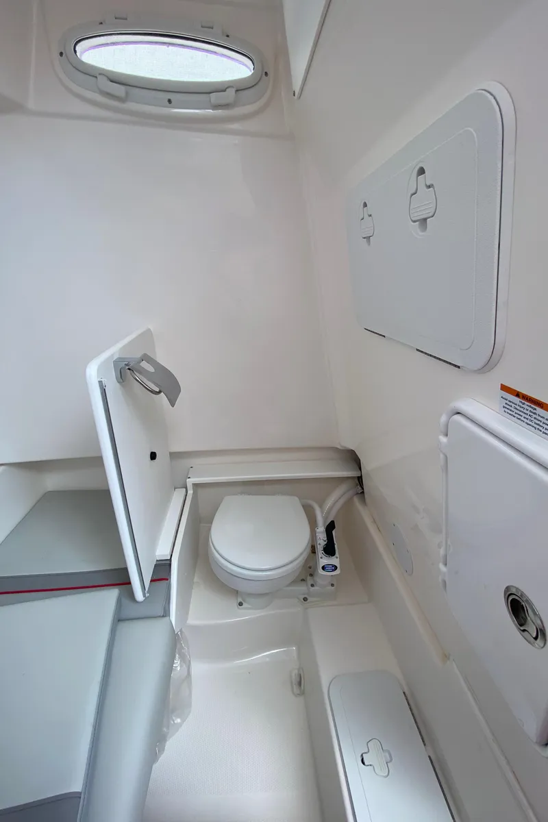 Slide: The Image of Compact bathroom in 2025 Solara S-250 CW boat with modern fixtures and storage compartments. - 24