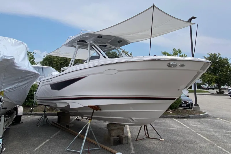 Slide: The Image of 2025 Solara S-250 CW boat on display, elevated on stands, with a canopy overhead. - 3
