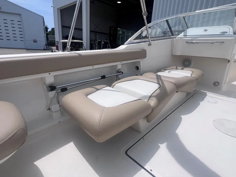 Slide: The Image of 2016 Key West 186 Dual Console boat interior with beige and white seating. - 10