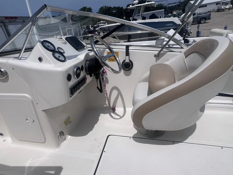 Slide: The Image of 2016 Key West 186 Dual Console boat interior with steering wheel and dashboard controls. - 11