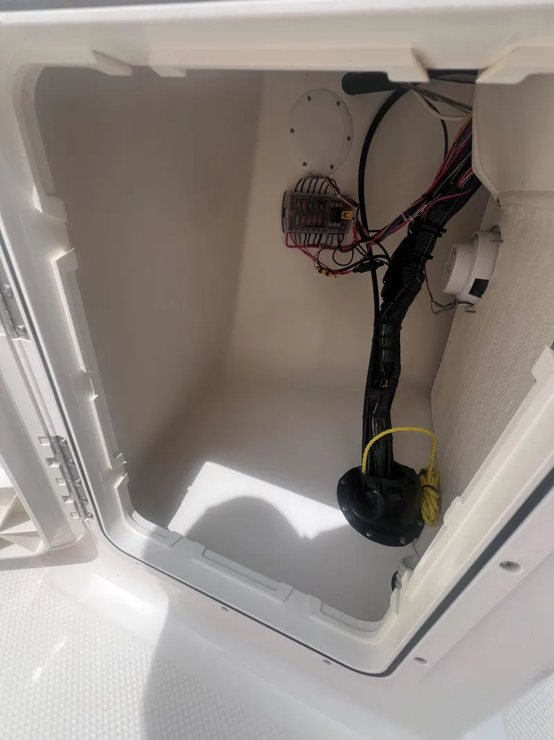 Slide: The Image of Open storage compartment with wiring in 2016 Key West 186 Dual Console boat. - 15