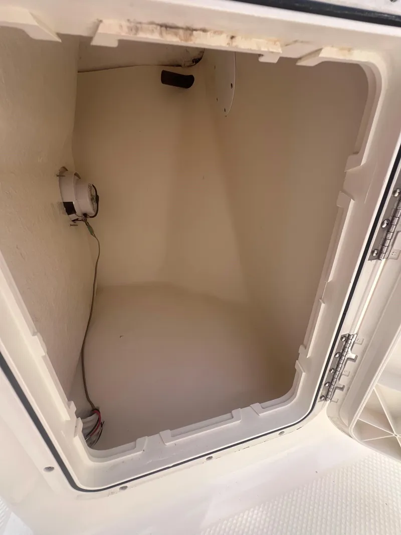 Slide: The Image of Open storage compartment in 2016 Key West 186 Dual Console boat. - 16