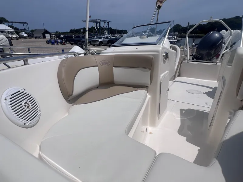 Slide: The Image of 2016 Key West 186 Dual Console boat interior with seating and speaker, docked at marina. - 17