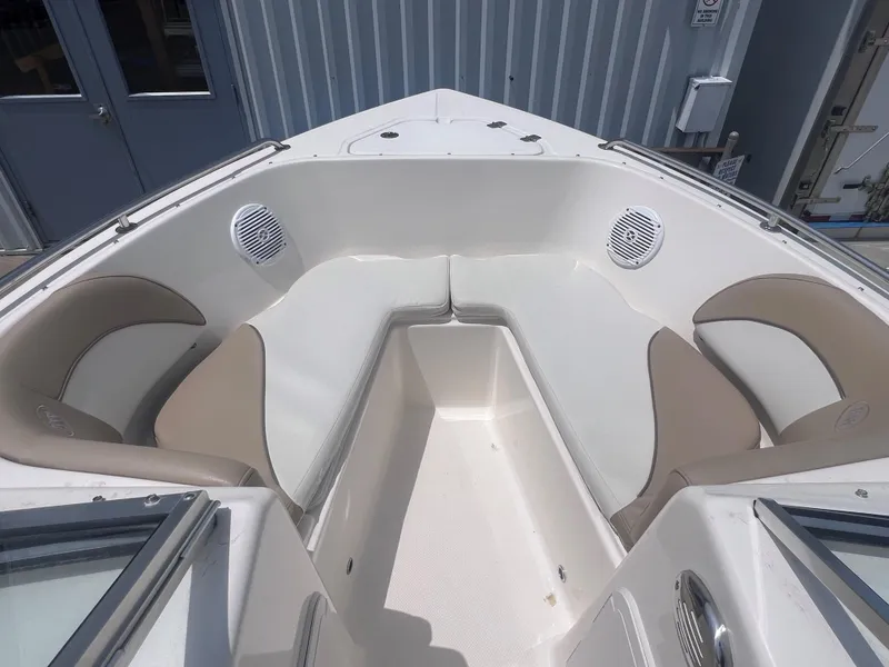 Slide: The Image of 2016 Key West 186 Dual Console boat interior with beige seating and speakers. - 18