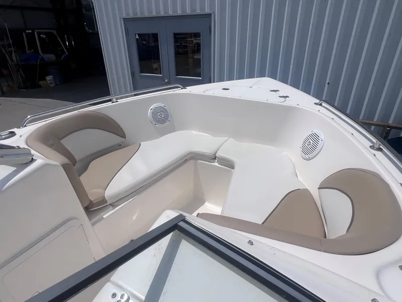 Slide: The Image of 2016 Key West 186 Dual Console boat interior with cushioned seating and speakers. - 19