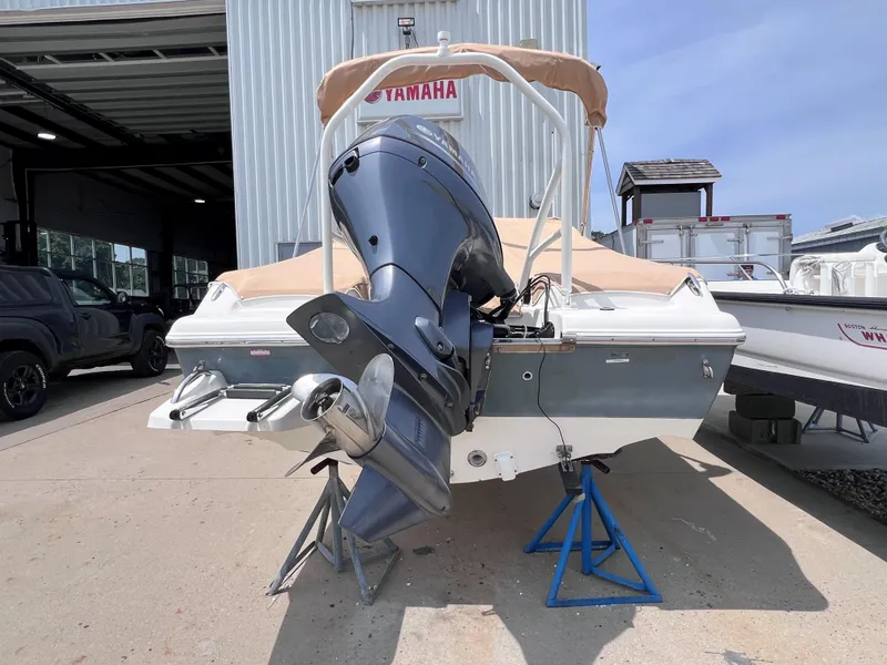 Slide: The Image of 2016 Key West 186 Dual Console boat with Yamaha outboard motor in a marina setting. - 2