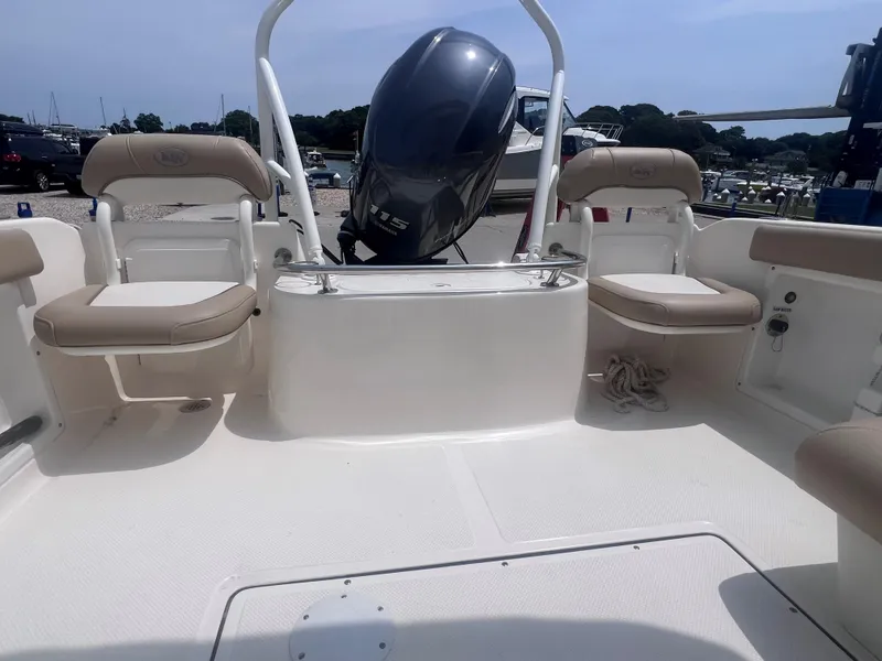 Slide: The Image of 2016 Key West 186 Dual Console boat interior with seating and outboard motor. - 4