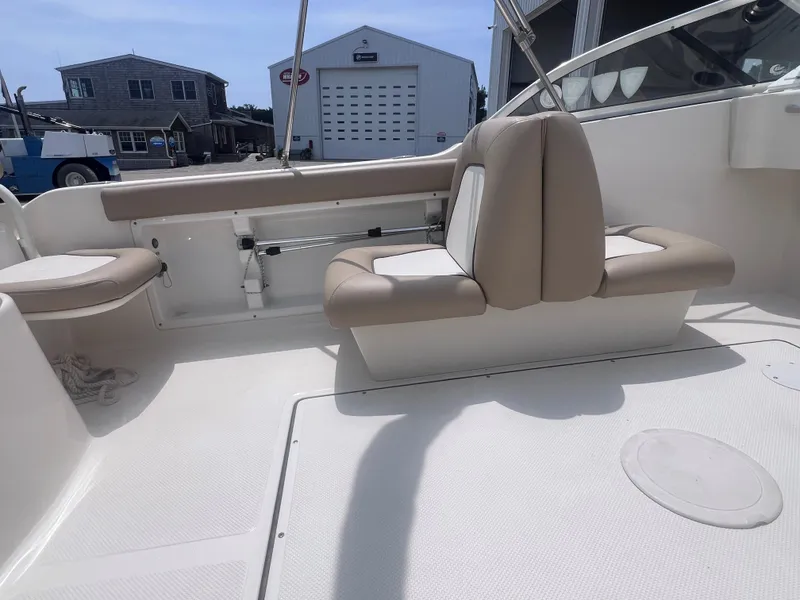 Slide: The Image of 2016 Key West 186 Dual Console boat interior with beige seating and white deck. - 7