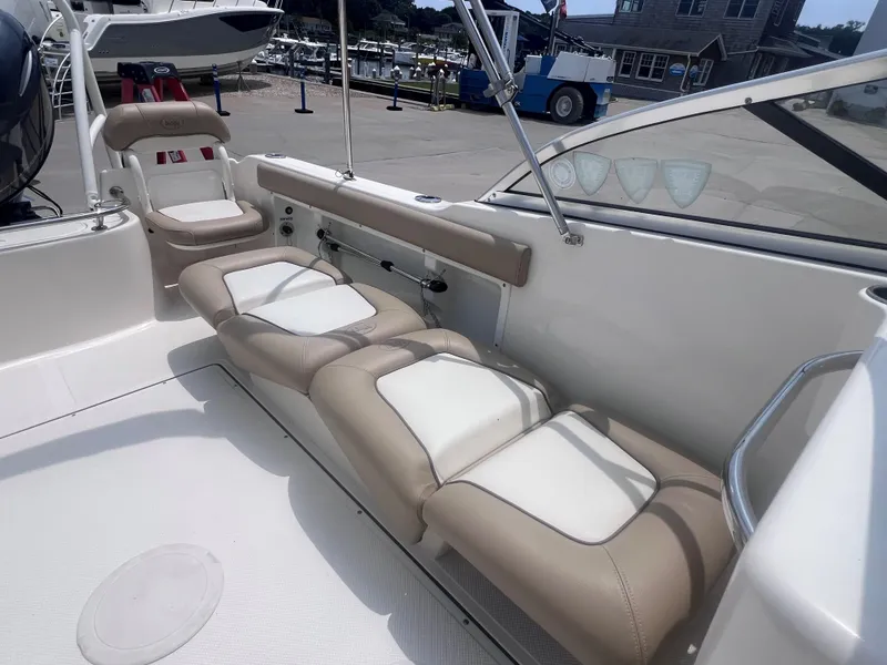 Slide: The Image of 2016 Key West 186 Dual Console boat interior with beige and white seating. - 8