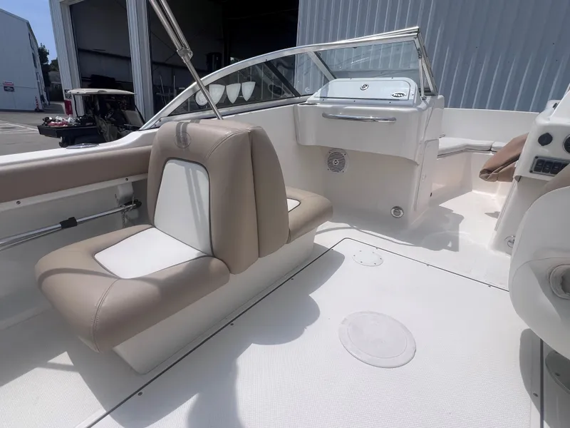 Slide: The Image of 2016 Key West 186 Dual Console boat interior with beige and white seating. - 9