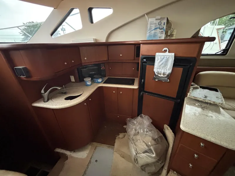 Slide: The Image of 2004 Silverton 35 Motor Yacht interior kitchen with sink, cabinets, and appliances. - 10