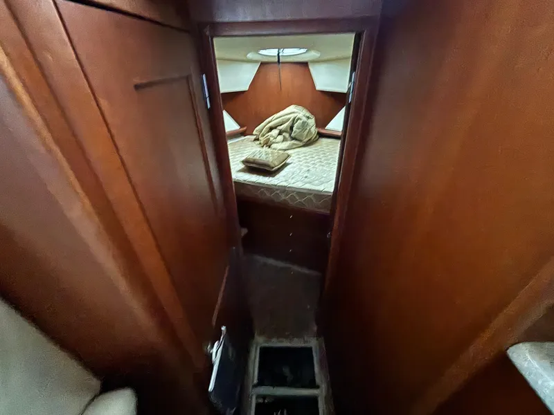 Slide: The Image of 2004 Silverton 35 Motor Yacht cabin interior with wood paneling and bed. - 11