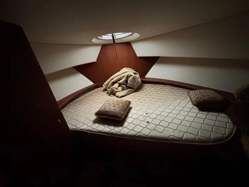 Slide: The Image of 2004 Silverton 35 Motor Yacht cabin interior with bed and pillows. - 12