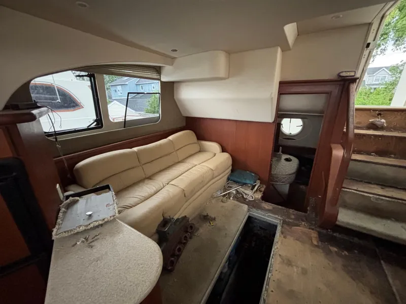 Slide: The Image of Interior of 2004 Silverton 35 Motor Yacht with beige sofa and wooden accents. - 15