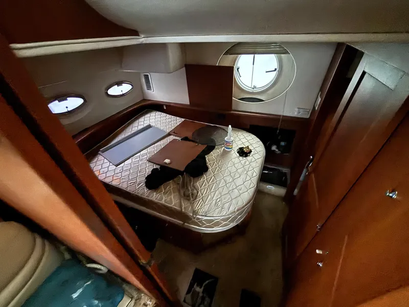 Slide: The Image of 2004 Silverton 35 Motor Yacht cabin interior with bed and porthole window. - 16