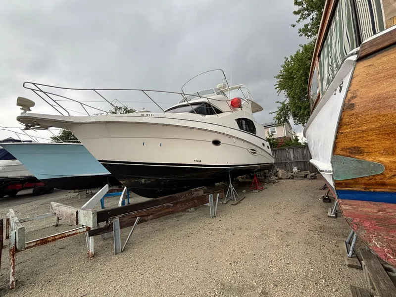 Slide: The Image of 2004 Silverton 35 Motor Yacht on dry dock, surrounded by other boats. - 3