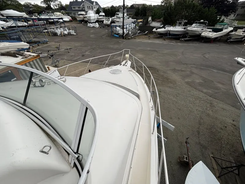 Slide: The Image of 2004 Silverton 35 Motor Yacht in a boatyard, surrounded by other vessels. - 6