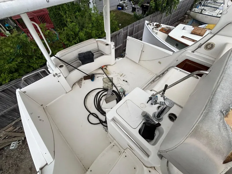 Slide: The Image of 2004 Silverton 35 Motor Yacht deck with seating and equipment, surrounded by greenery. - 7