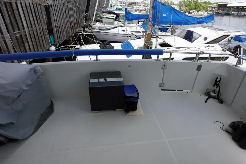 Slide: The Image of 2004 Carver 396 Aft Cabin MY boat deck with marina view and covered equipment. - 16
