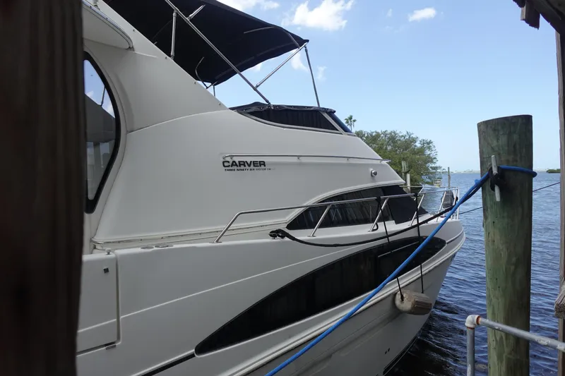 Slide: The Image of 2004 Carver 396 Aft Cabin MY yacht docked by the water. - 18