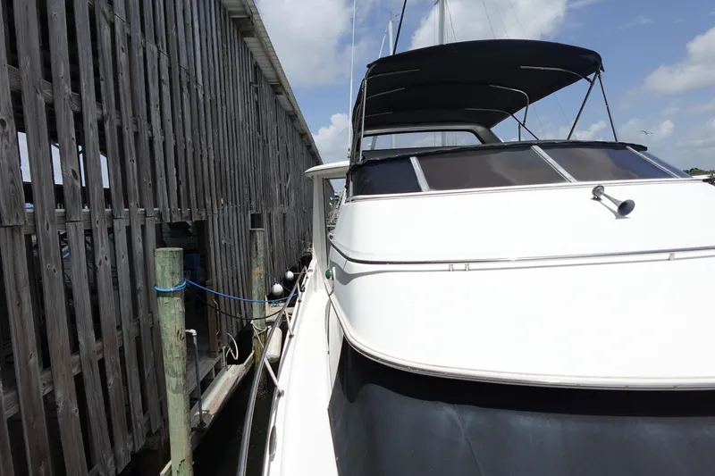 Slide: The Image of 2004 Carver 396 Aft Cabin MY yacht docked beside wooden pier. - 20