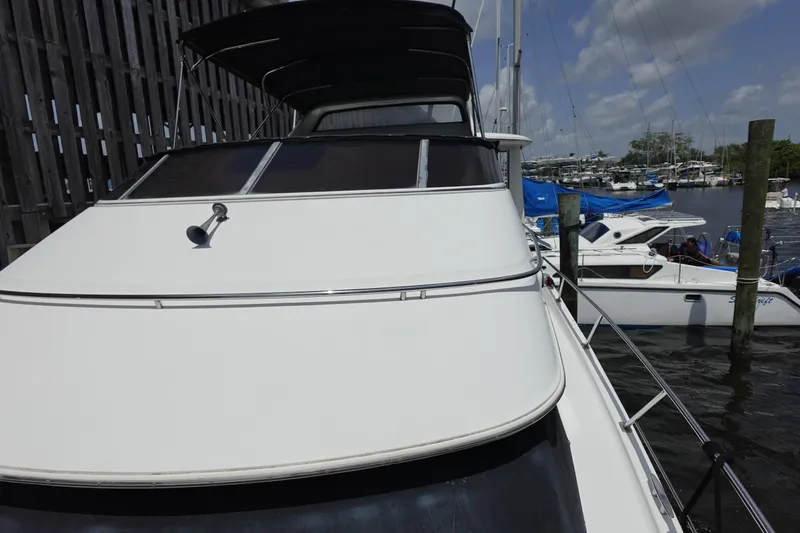Slide: The Image of 2004 Carver 396 Aft Cabin MY docked at marina under cloudy sky. - 22