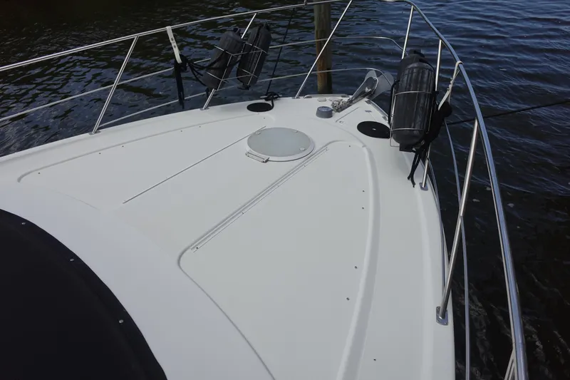 Slide: The Image of 2004 Carver 396 Aft Cabin MY boat deck with railings and water view. - 23