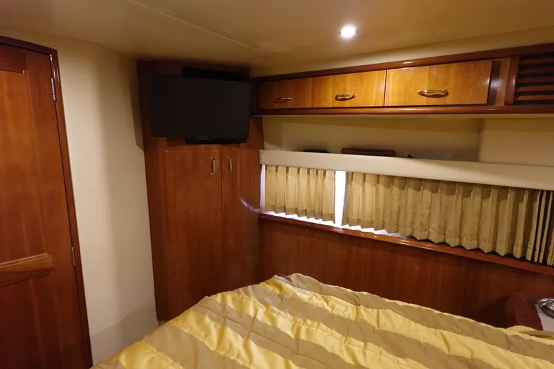 Slide: The Image of Interior of 2004 Carver 396 Aft Cabin MY with wood cabinets and TV. - 27